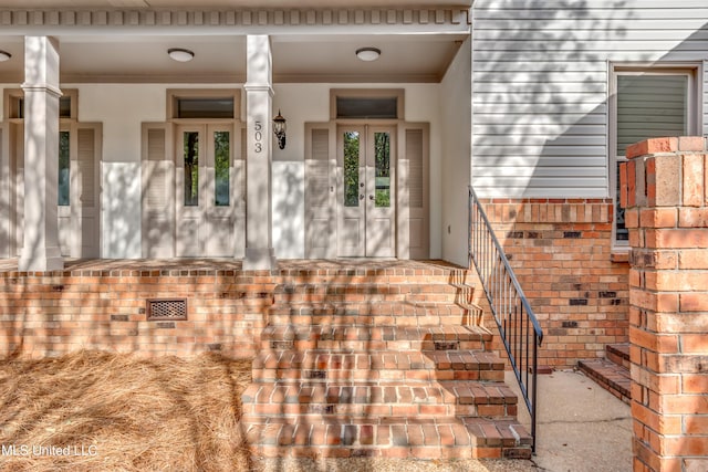 view of exterior entry featuring french doors