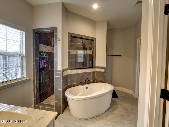 bathroom with tile patterned floors and independent shower and bath