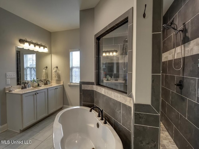 bathroom with vanity and shower with separate bathtub