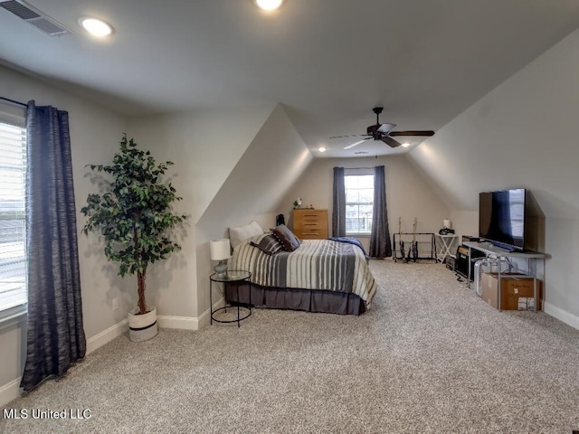 carpeted bedroom with ceiling fan and vaulted ceiling