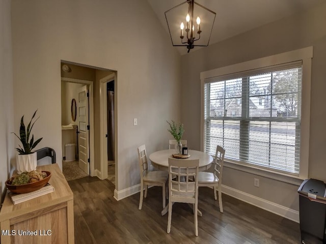 dining room with a chandelier, dark wood-type flooring, and vaulted ceiling