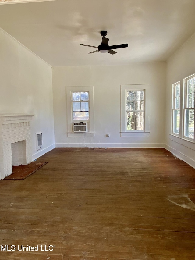 unfurnished living room featuring baseboards, dark wood finished floors, ceiling fan, cooling unit, and a fireplace