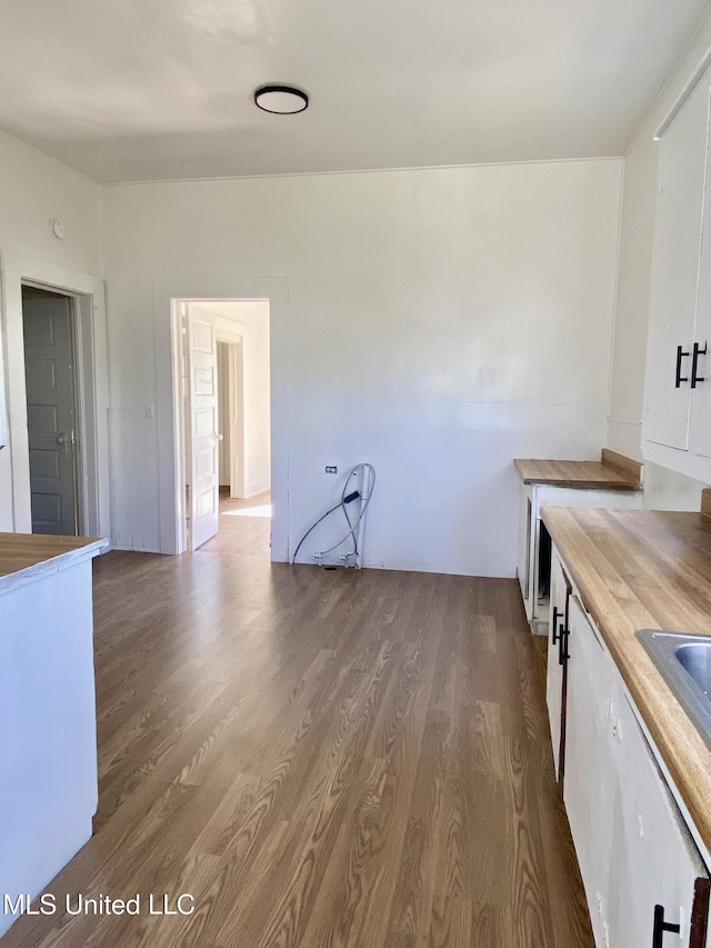 kitchen featuring white cabinetry, wooden counters, and wood finished floors