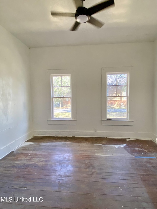 spare room featuring ceiling fan, baseboards, and hardwood / wood-style floors