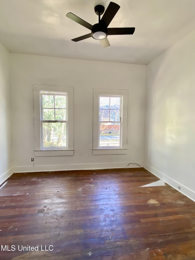 spare room with ceiling fan, baseboards, and wood finished floors