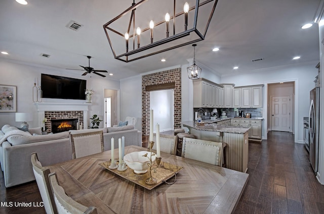 236 Cooper Ln, Canton, MS 39046 - dining space featuring ornamental molding, visible vents, ceiling fan, and a glass covered fireplace