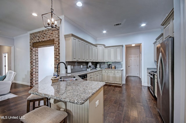 236 Cooper Ln, Canton, MS 39046 - kitchen featuring a kitchen bar, a peninsula, light stone counters, a sink, and stainless steel appliances