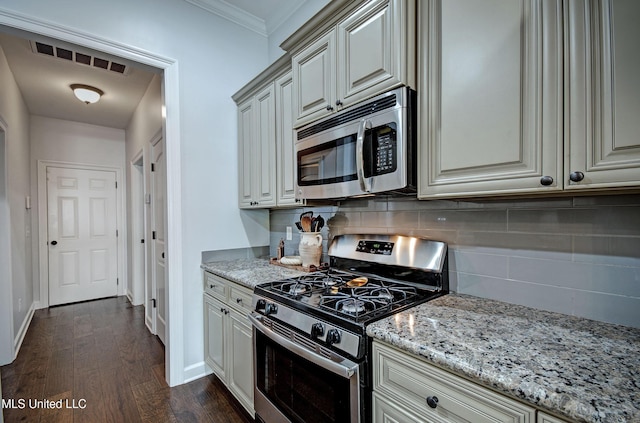 236 Cooper Ln, Canton, MS 39046 - kitchen featuring backsplash, light stone countertops, dark wood-type flooring, visible vents, and appliances with stainless steel finishes