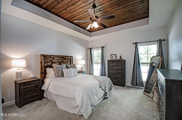 236 Cooper Ln, Canton, MS 39046 - bedroom with a tray ceiling, wood ceiling, light colored carpet, and multiple windows