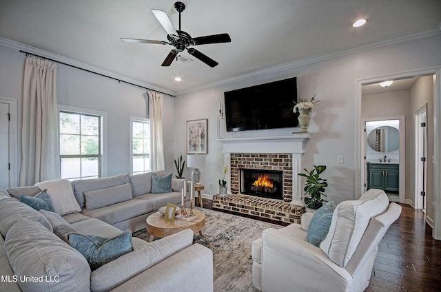 236 Cooper Ln, Canton, MS 39046 - living room featuring crown molding, ceiling fan, dark wood-style floors, and a brick fireplace