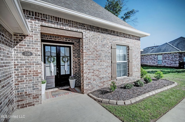 236 Cooper Ln, Canton, MS 39046 - view of exterior entry with a shingled roof and brick siding
