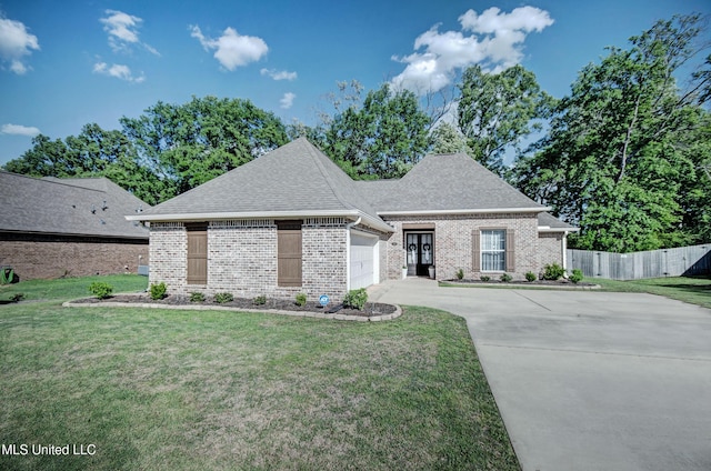 236 Cooper Ln, Canton, MS 39046 - french country inspired facade featuring a front yard, a garage, fence, brick siding, and driveway