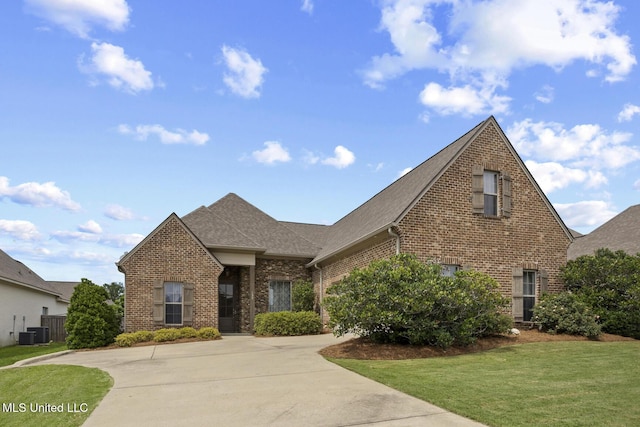 133 Sweetbriar Dr, Canton, MS 39046 - view of front of property with brick siding, a front lawn, roof with shingles, and central air condition unit