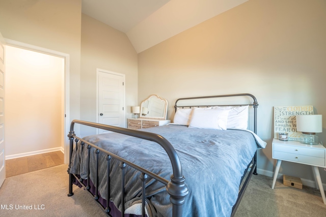 carpeted bedroom with high vaulted ceiling