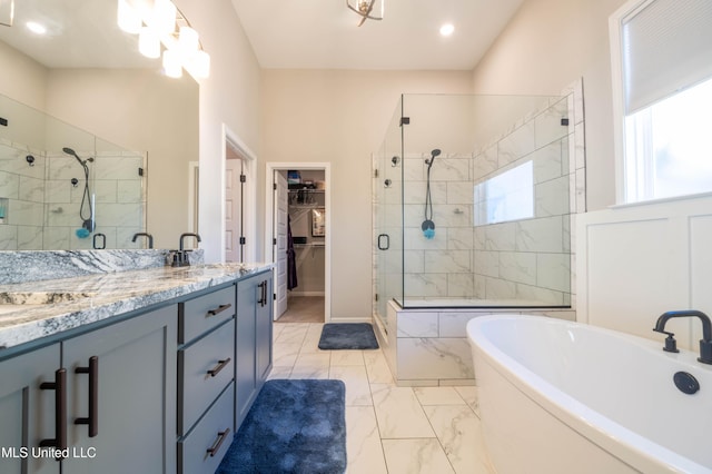 bathroom featuring separate shower and tub and vanity