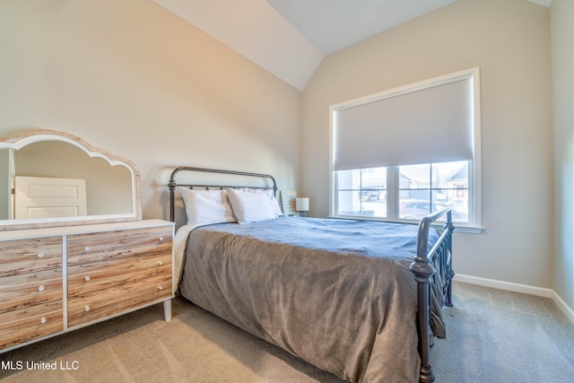 carpeted bedroom featuring vaulted ceiling