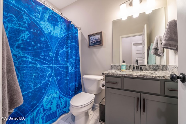 bathroom featuring toilet, tile patterned floors, and vanity