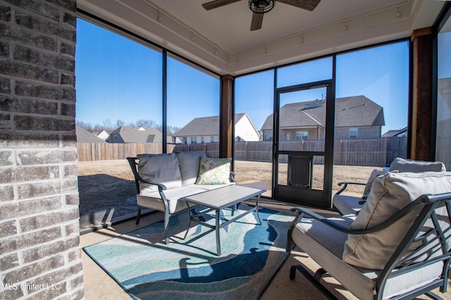 sunroom with ceiling fan