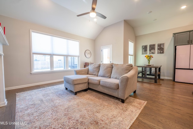 living room featuring lofted ceiling, ceiling fan, and dark wood-type flooring