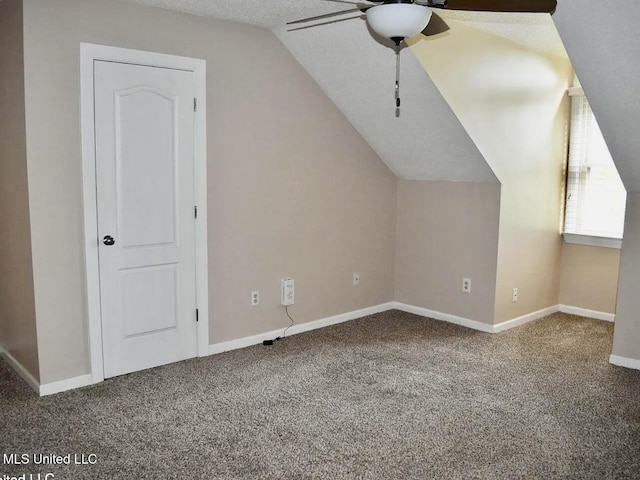 bonus room with lofted ceiling, ceiling fan, and carpet