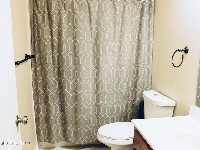 bathroom featuring toilet, curtained shower, and vanity