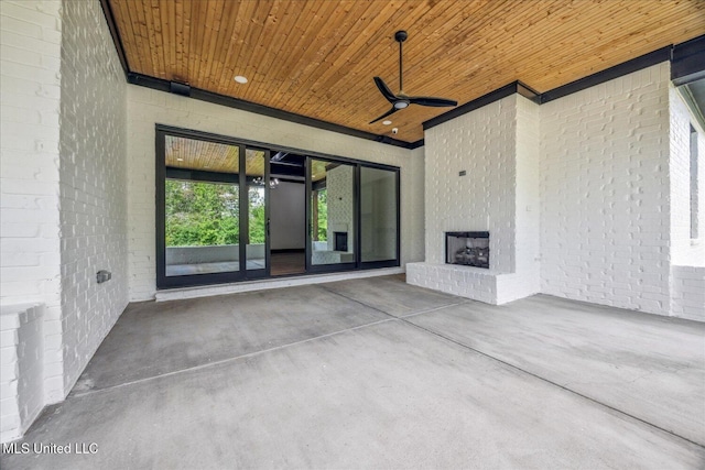 view of patio / terrace with a ceiling fan and an outdoor brick fireplace