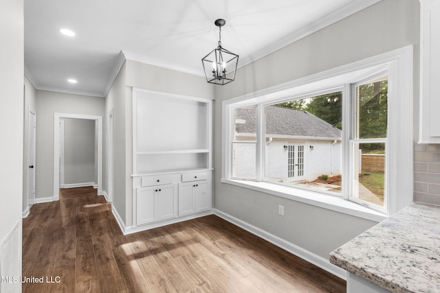 112 Louis Wilson Dr, Brandon, MS 39042 - unfurnished dining area featuring dark wood-style floors, a chandelier, ornamental molding, and recessed lighting