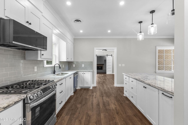 112 Louis Wilson Dr, Brandon, MS 39042 - kitchen with stainless steel appliances, ornamental molding, white cabinetry, dark wood-style floors, and backsplash