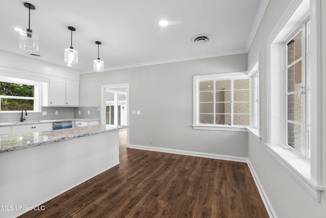 112 Louis Wilson Dr, Brandon, MS 39042 - kitchen with white cabinets, crown molding, dishwasher, dark wood finished floors, and light stone countertops