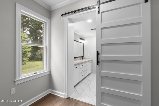 112 Louis Wilson Dr, Brandon, MS 39042 - walk in closet featuring a barn door and marble look tile flooring