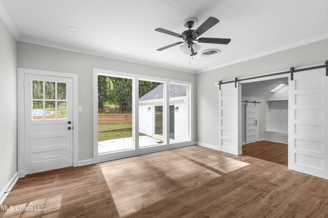 112 Louis Wilson Dr, Brandon, MS 39042 - unfurnished bedroom with a barn door, access to outside, wood finished floors, crown molding, and a ceiling fan