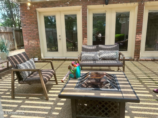 view of patio / terrace with french doors and a fire pit