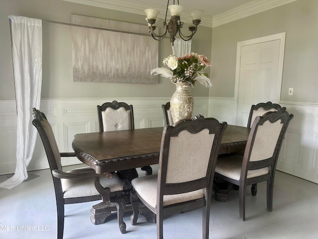 dining space featuring crown molding and an inviting chandelier