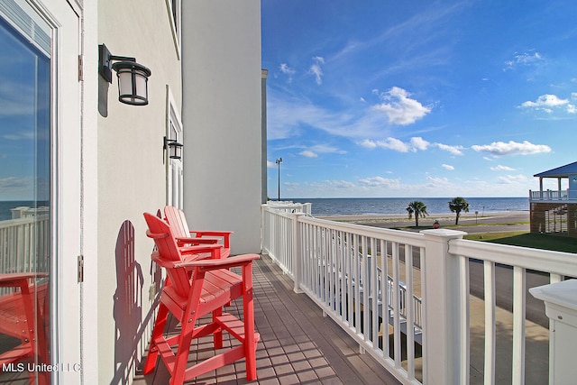 balcony with a water view and a beach view