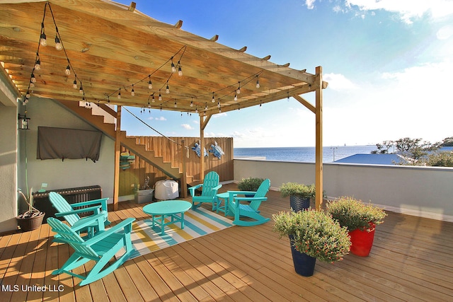 wooden terrace featuring a water view