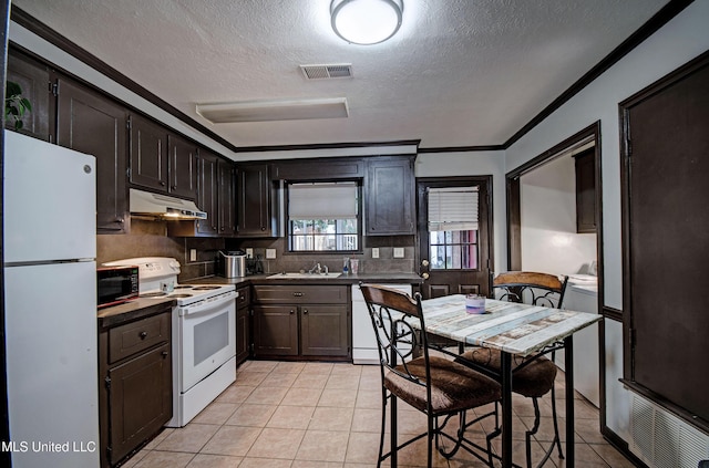 100 Eager St Unit C, Clinton, MS 39056 - kitchen with white appliances, under cabinet range hood, a textured ceiling, tasteful backsplash, and light tile patterned flooring