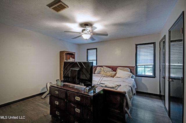 100 Eager St Unit C, Clinton, MS 39056 - bedroom with multiple windows, dark wood-style floors, a ceiling fan, and a textured ceiling