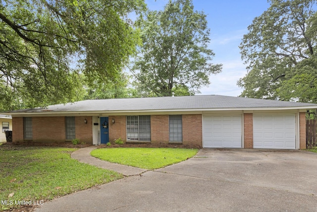 ranch-style home with a garage, driveway, brick siding, and a front yard