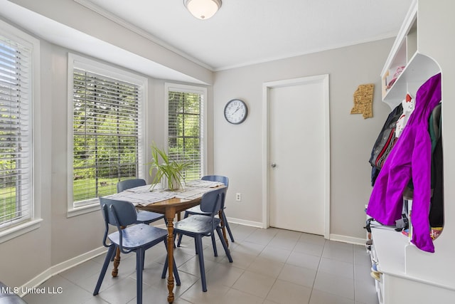 dining room with baseboards and ornamental molding