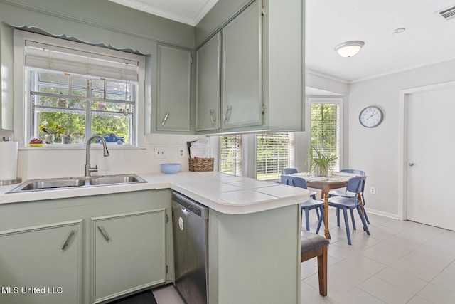 kitchen featuring crown molding, light countertops, a sink, and dishwasher