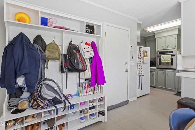 mudroom featuring crown molding and light tile patterned floors