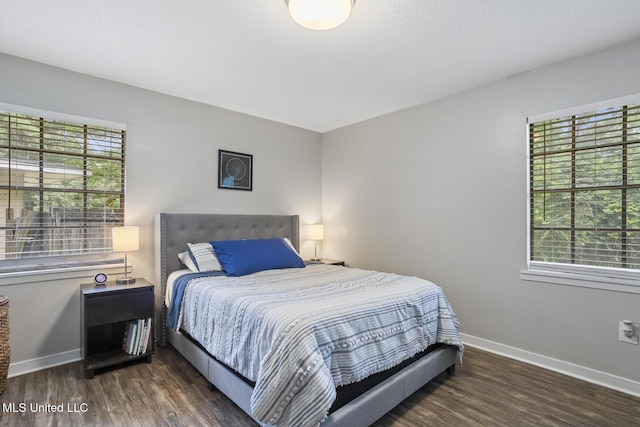 bedroom featuring baseboards and wood finished floors