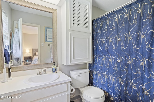 ensuite bathroom with toilet, ensuite bathroom, and vanity