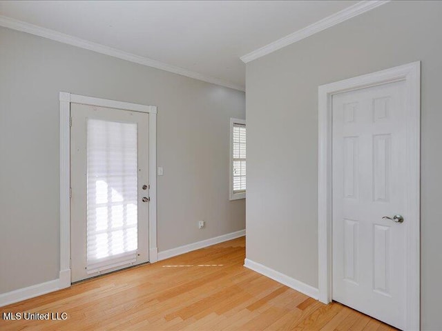 foyer entrance with ornamental molding, baseboards, and light wood-style floors