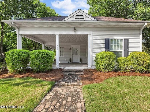 exterior space featuring a porch and a yard