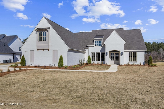 view of front of home featuring a front lawn and central air condition unit