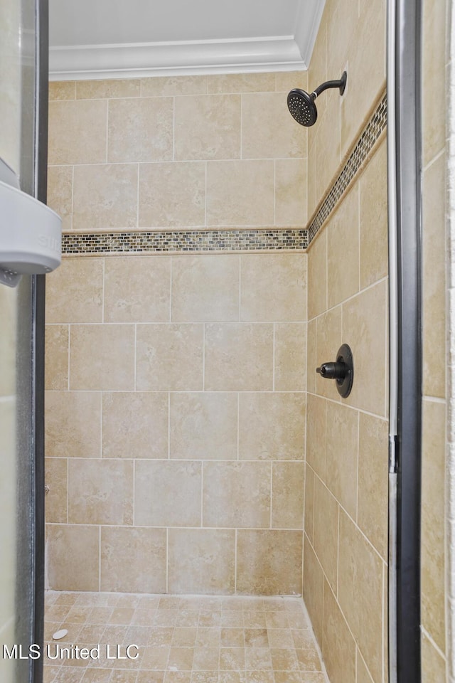 bathroom with a stall shower and ornamental molding