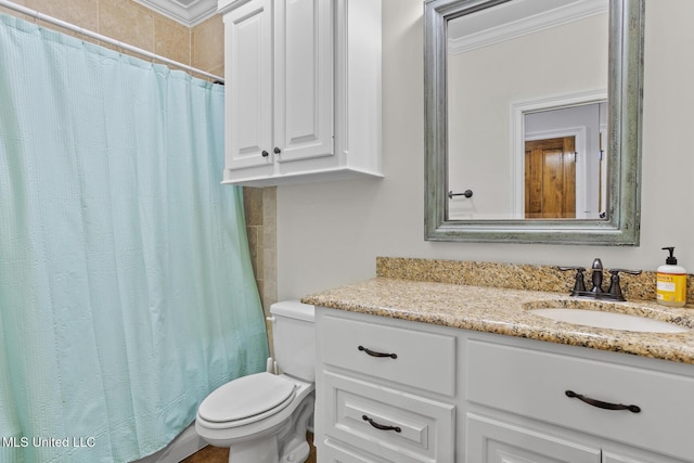 bathroom with ornamental molding, curtained shower, vanity, and toilet