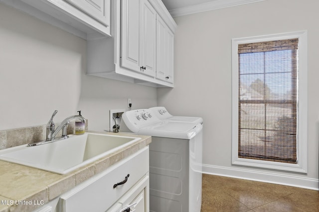 laundry room with crown molding, cabinet space, a sink, independent washer and dryer, and baseboards