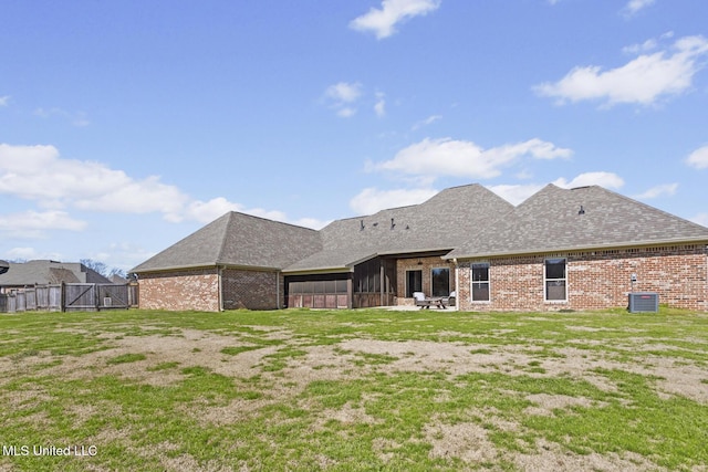 rear view of house featuring brick siding, a shingled roof, fence, and cooling unit